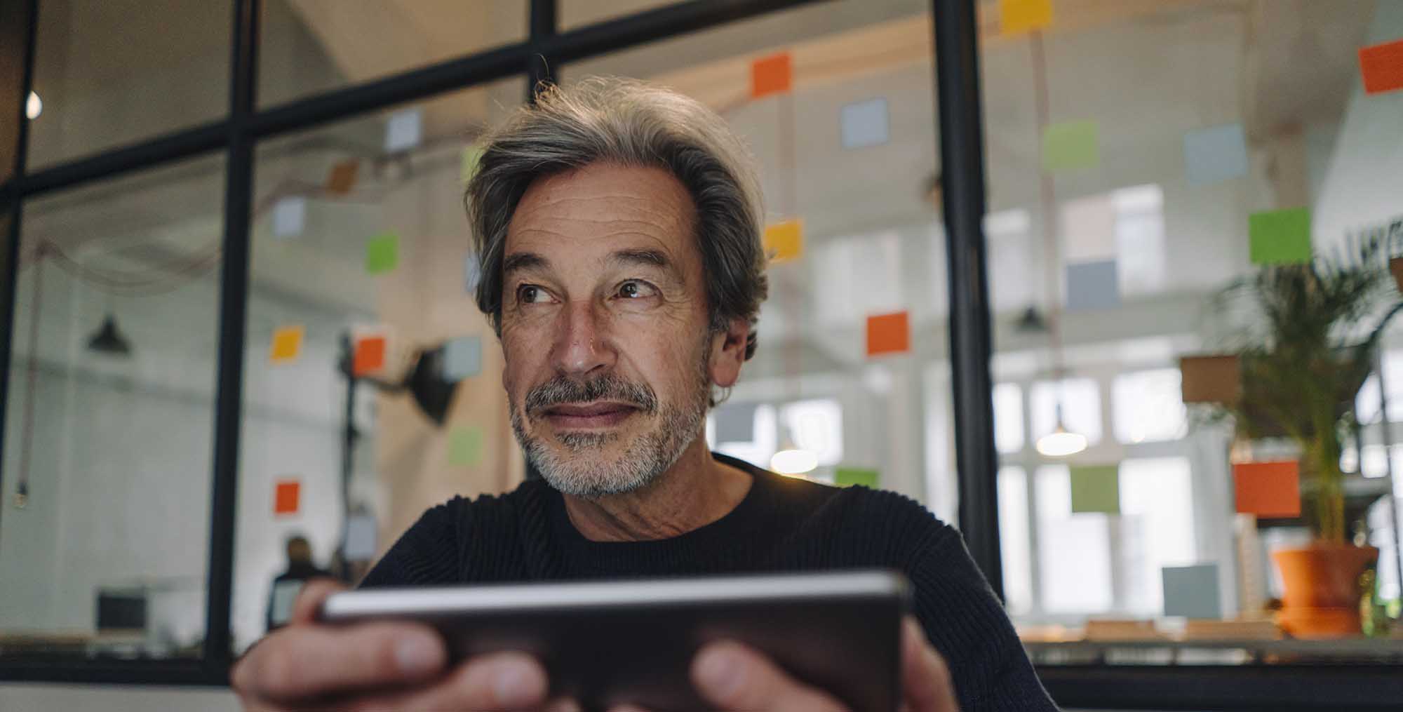 Senior businessman with tablet in office